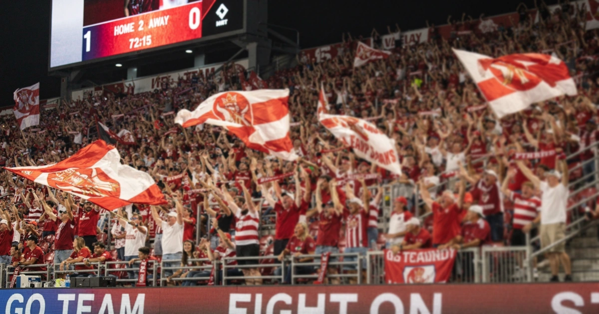 Packed stadium with passionate home crowd supporting their team